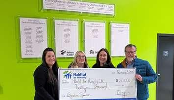 Cheque presentation. Anne Taylor, Director of Partnerships and Stakeholder Relations, Habitat for Humanity Chatham-Kent; Amy Adams, Entegrus & Habitat Board Member; Sarah Regnier-Pittman, Entegrus; and Jim Hogan, President & CEO, Entegrus (Image courtesy of Entegrus)