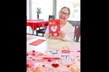 A local woman enjoys a Valentine's Day card collected by the Lambton County Library. February 14, 2024 (Photo courtesy of LCLibrary Facebook)