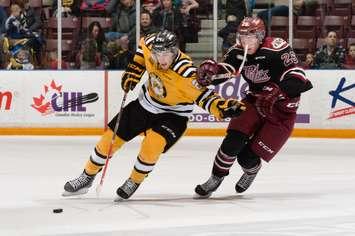 Kevin Spinozzi fights off a check from Peterborough forward Josh Coyle. Photo by Metcalfe Photography 