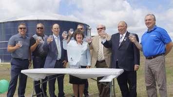 Local dignitaries and those in charge of construction of the Mandaumin reservoir expansion raise  a glass of water to toast its official opening. July, 14, 2017 (Photo by Melanie Irwin)