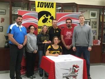 LCCVI student Marissa Mueller signs her scholarship with Iowa University. Pictured L-R: SW Athletics coach Joel Skinner, LCCVI T&F coach Sara Krawetz, Krista and Peter Mueller (mom & dad), Joel Campbell (LCCVI T&F coach) and coach Andrew Westlake. (submitted photo)
