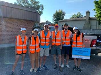 Volunteers with nuSarnia installing a temporary protected bike lane.  August 2022.  (Photo provided by nuSarnia)