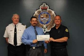 (From L to R) Chief Phil Nelson, event organizer Detective Constable Ken McLachlin and local Torch Run representative Morgan Tyler from the Ministry of Corrections. (Photo submitted by the Sarnia Police Service)