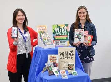 Lambton County Library staff members Adrianne Lebert (left) and Vanitia Campbell showcase materials for Lambton County Library's "Wild Wonder" Summer Reading Challenge, including book prizes and registration kits. Submitted photo.