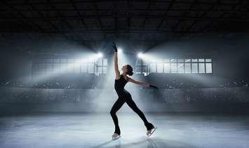 A figure skater in an arena stock photo (photo courtesy: Artur Didyk/ iStock / Getty Images Plus)