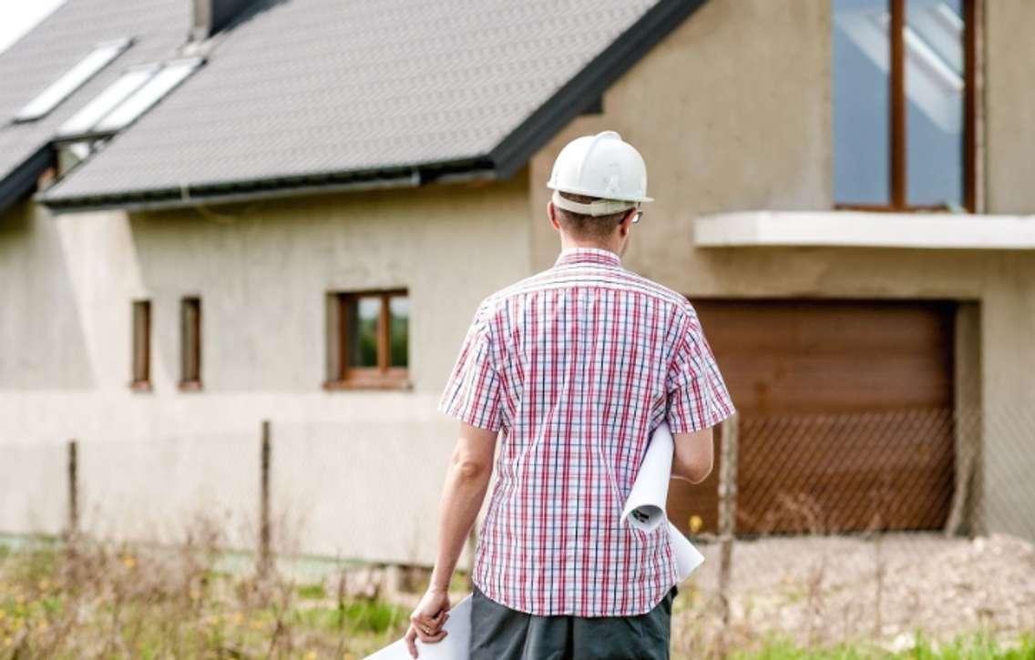 An engineer stands outside a  newly built house. June 27, 2017. (Photo from Pixnio)