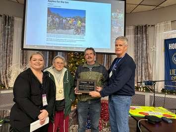 Lorena Macklin and son Joel were presented with a plaque by Adrienne McPhee, Programs Manager, The Inn of the Good Shepherd, and Dennis Loucks, Past President of the the Kiwanis Club of Sarnia-Lambton Golden K, on Tuesday, December 5 during the weekly Kiwanis meeting (Submitted photo)