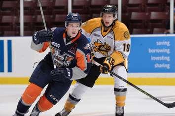 Sarnia's Ryan McGregor battles with Flint's Cullen Mercer. Photo by Metcalfe Photography