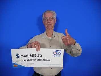 Jon Walsh of Bright's Grove with his LOTTO 6/49 winnings (Photo by: OLG)