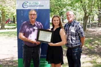 Laura Benedict is awarded with the Mary Jo Arnold Conservation Scholarship by St. Clair Region Conservation Authority Chair, Joe Faas (left) and Vice-Chair, Larry Gordon (right).