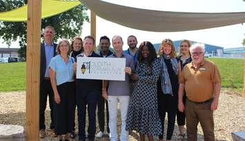 Representatives from the YMCA and Judith & Norman Alix Foundation gather to celebrate a completed playground at the Jerry MCCaw Family Centre. Submitted.