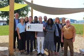 Representatives from the YMCA and Judith & Norman Alix Foundation gather to celebrate a completed playground at the Jerry MCCaw Family Centre. Submitted.