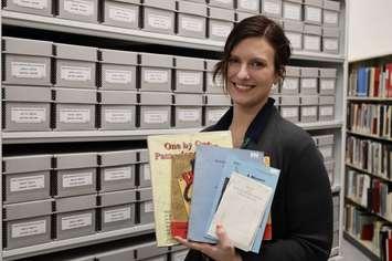 Archivist/Supervisor Nicole Aszalos holds examples of books for sale. February 15, 2024. (Photo courtesy of Lambton County Archives)