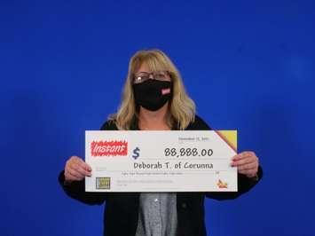 Deborah (Debbie) Taylor of Corunna wins $88,888 prize (Photo courtesy of OLG)