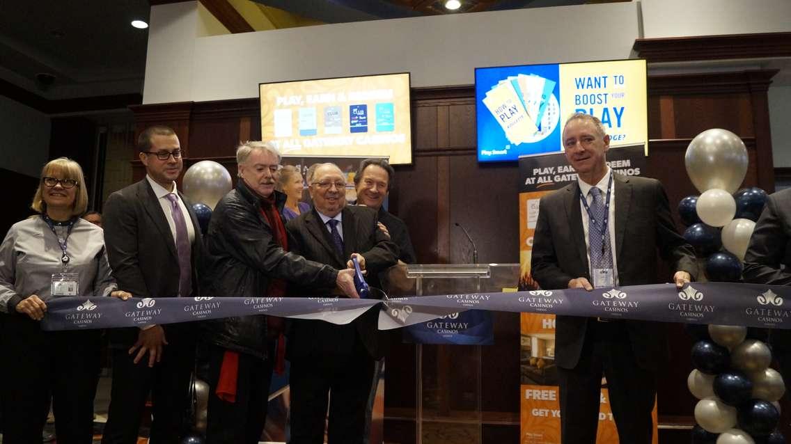 Sarnia Mayor Mike Bradley (red scarf) and MPP Bob Bailey cut the ribbon at Gateway Casino Sarnia from Hiawatha Horse Park. 30 January 2020. (BlackburnNews.com photo by Colin Gowdy)