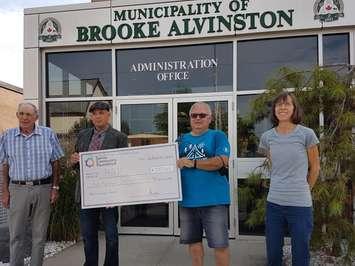 Don McGugan and Dave Ferguson present a
grant for the Hope Alvinston Ministries Camp program to Jim Breen and Pasty Ikert. (Photo courtesy of the Sarnia Community Foundation).