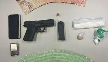 Drugs, money and a handgun seized from a home in central Sarnia, June 14, 2024 (Photo by: Sarnia police)
