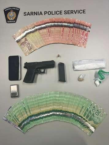Drugs, money and a handgun seized from a home in central Sarnia, June 14, 2024 (Photo by: Sarnia police)