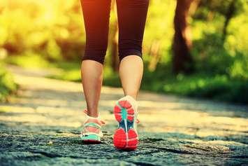Woman walking on a trail. File photo courtesy of © Can Stock Photo / lzf
