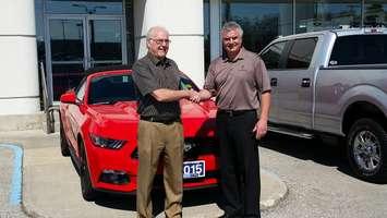 Harold Hall (left) transfers ownership of Lambton Ford to new President Rob Ravensberg (right). June 15, 2015. (photo by Jake Jeffrey blackburnnews.com)