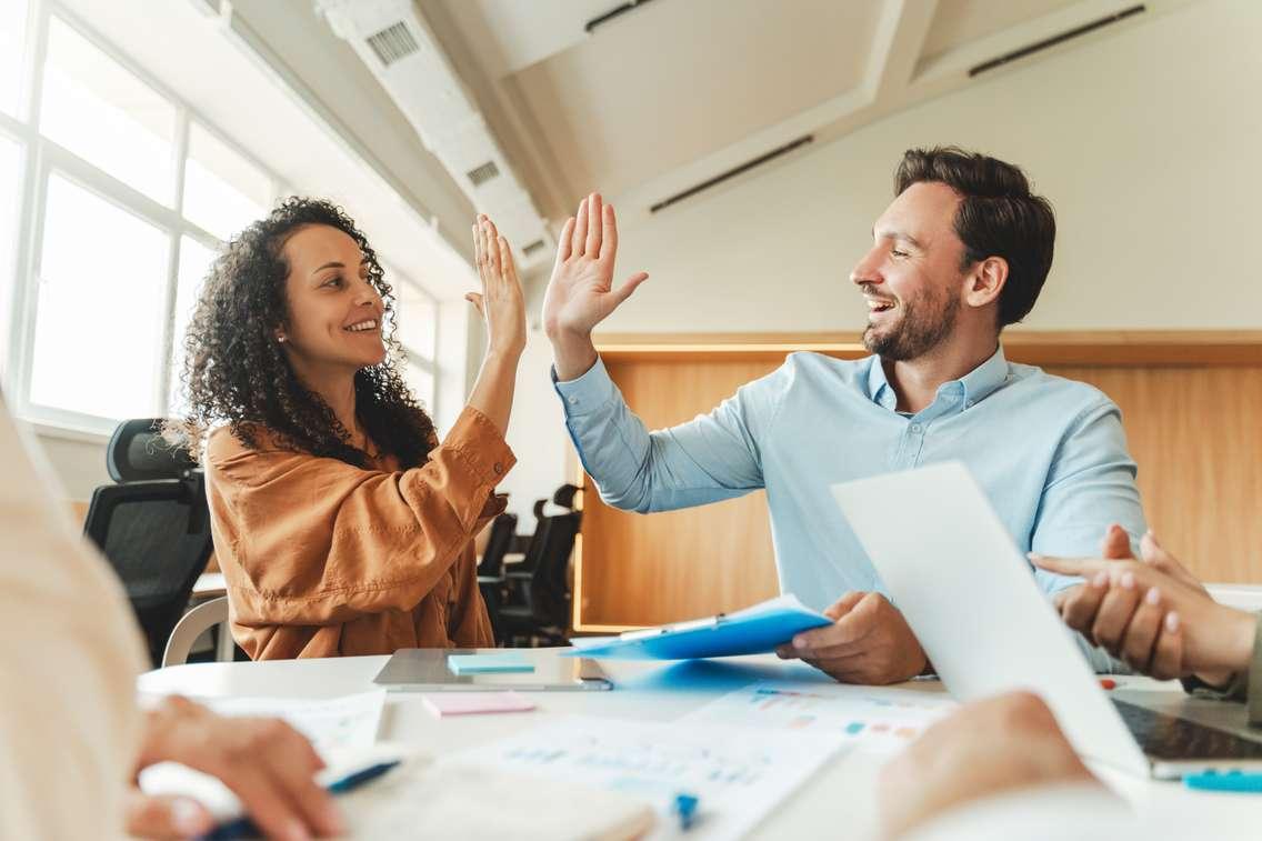 Business people celebrating. Photo by Mariia Vitkovska / iStock / Getty Images Plus via. Getty Images