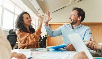 Business people celebrating. Photo by Mariia Vitkovska / iStock / Getty Images Plus via. Getty Images