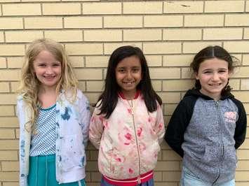 Brooke Reiger, Amisha Duggal, and Ava Salem organize a charity garage sale. June 2022. (Photo courtesy of Parveen Duggal)