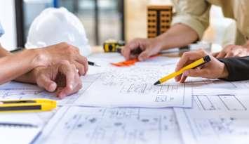 Engineering team checks construction blueprints on new project. Photo by Yok_Piyapong / iStock / Getty Images Plus via Getty Images