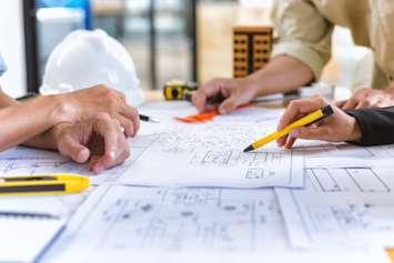 Engineering team checks construction blueprints on new project. Photo by Yok_Piyapong / iStock / Getty Images Plus via Getty Images
