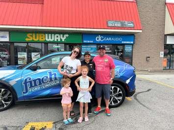 Trevor Taylor, the manager of subway and the family who received a free subway gift card (Photo by: Lindsay Newman/ Blackburn Media)