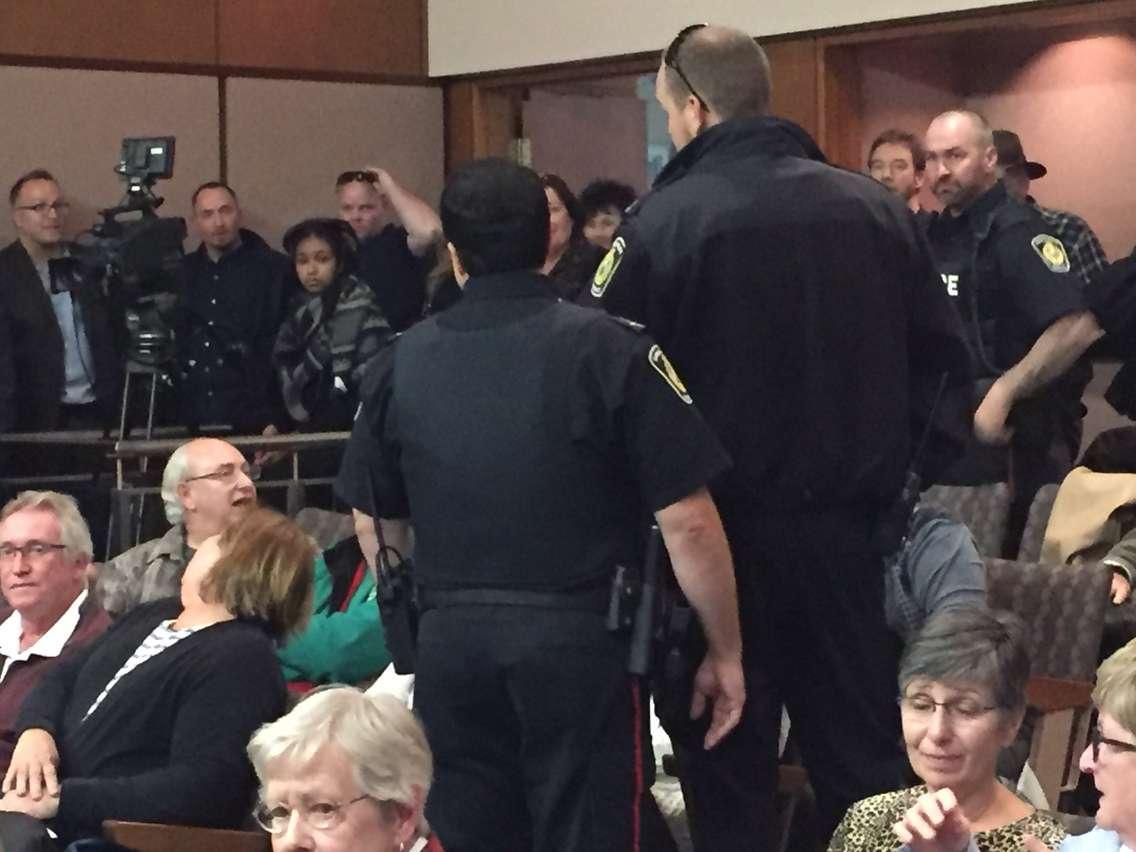 Sarnia police officers ask an individual to leave city council chambers during a contentious meeting. October 24, 2016. Blackburn Media photo by Melanie Irwin.