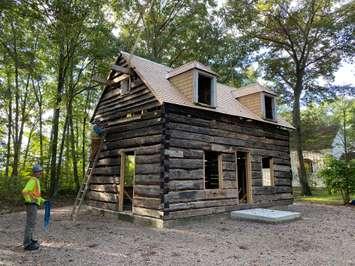 The roof is placed on the Canatara Cabin. Image courtesy of the Lambton Heritage Museum.