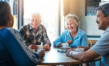 Seniors at a cafe drinking coffee. Photo by Jacob Wackerhausen / iStock / Getty Images Plus via Getty Images.
