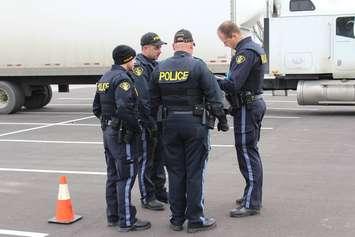 Police officers study a safety inspection report as part of their training. December 9, 2015. (Photo by Simon Crouch)