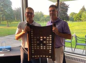 Adam Graham (left) receives a plaque from Jamie Parkinson (right) for winning the 2023 Sarnia Golf & Curling Club Annual Men’s Invitational Golf Tournament.