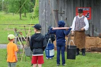 Visitors participate in historical blacksmith demonstration. (Photo courtesy of Lambton County Museums and Archives)
