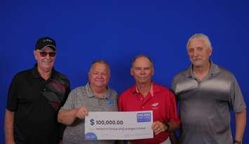 Four of the Lambton County winners collecting their $100,000 prize (Photo by: OLG)