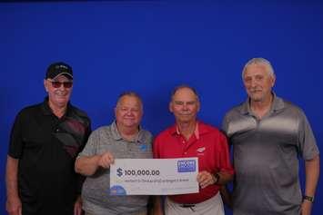 Four of the Lambton County winners collecting their $100,000 prize (Photo by: OLG)