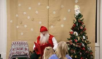 Victorian Santa reads stories to children. (Photo courtesy of The Corporation of the County of Lambton)