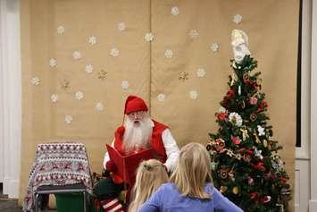 Victorian Santa reads stories to children. (Photo courtesy of The Corporation of the County of Lambton)