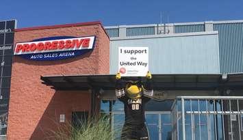 Sarnia Sting mascot holding a United Way of Sarnia-Lambton sign outside Progressive Auto Sales Arena.  (Photo by Sarnia Sting)