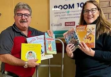 Inn of the Good Shepherd Executive Director Myles Vanni accepts books from Literacy Lambton Executive Director Tracy Pound. Submitted photo.