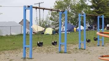 Tents by the swings at Rainbow Park, May 16, 2024 (Photo by: Lindsay Newman/ Blackburn Media)