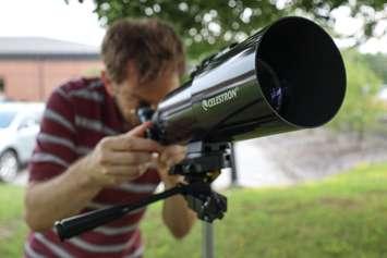 Technical Services Clerk Paolo Viola uses the new telescope kit from Lambton County Library. August 7, 2024. (Photo courtesy of The Corporation of the County of Lambton)