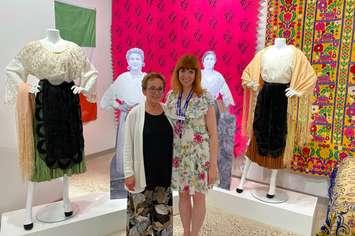 Lambton Heritage Museum Curator/Supervisor Dana Thorne (right) and exhibit contributor Antonia Ambrose (left) stand next to Italian dresses. Submitted photo.  