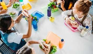 Kids having lunch. Photo by LightFieldStudios. 	iStock / Getty Images Plus