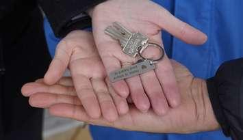 One of the new Habitat for Humanity homeowners holding the key for their new home (Photo by: Lindsay Newman/ Blackburn Media)