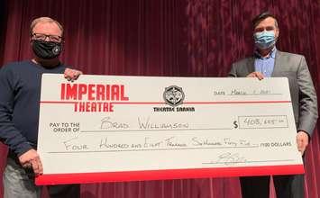 Brad Williamson (left) receiving his 50/50 winnings from Imperial Theatre Executive Director Brian Austin (right). March 2021. (Submitted photo)