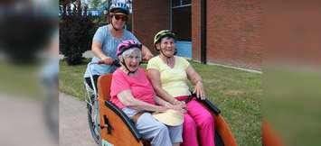 Residents at North Lambton Lodge in Forest take a ride on a trishaw. July 30, 2019. (Photo by County of Lambton)