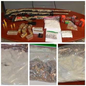 Chatham-Kent police display some of the weapons, ammo and drugs that were seized after carrying out a search warrant at a residence in the Dresden area on Thursday, September 29, 2022. (Photo courtesy of Chatham-Kent police)